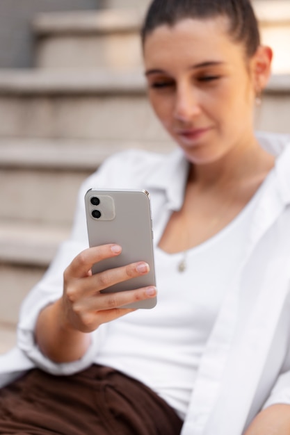 Free photo close up smiley woman holding smartphone