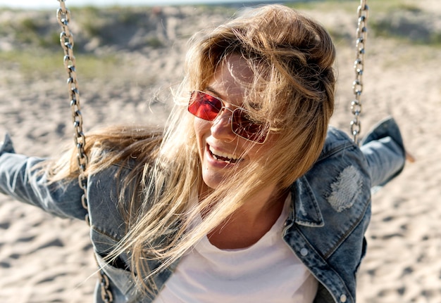 Free Photo close-up smiley woman on swing