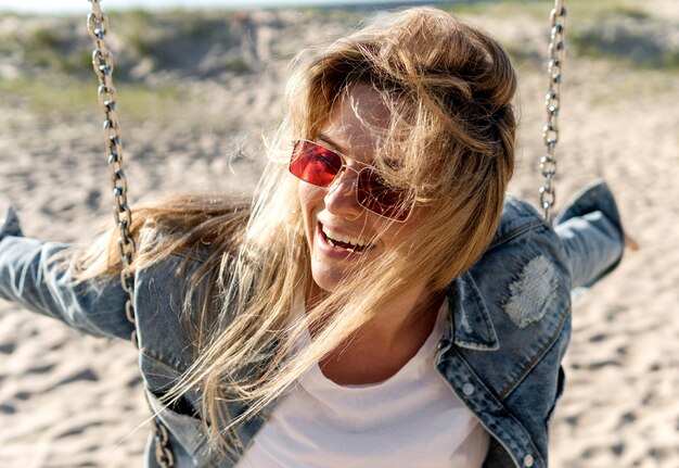 Close-up smiley woman on swing