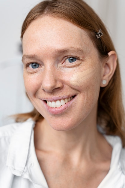 Close up smiley woman wearing foundation