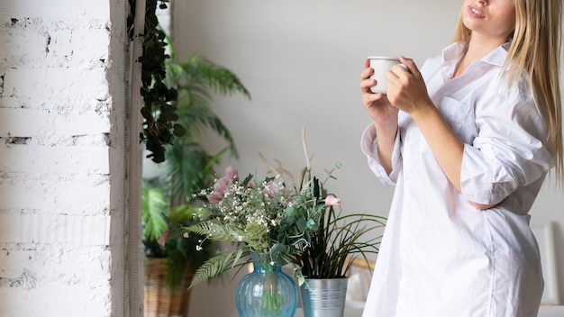 Free photo close-up smiley woman with cup of coffee