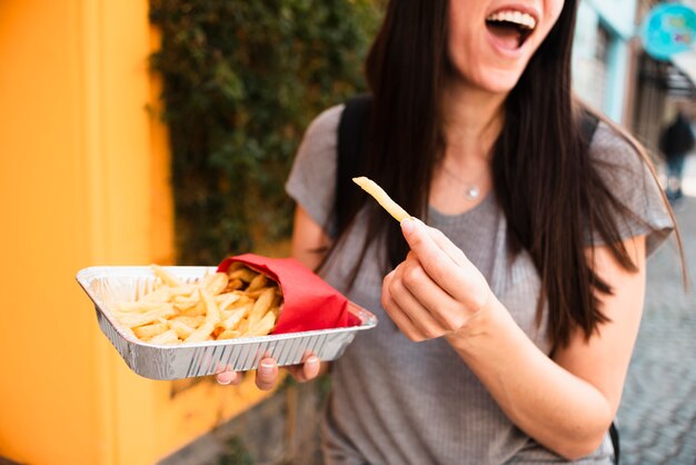 Close-up smiley woman with french fries