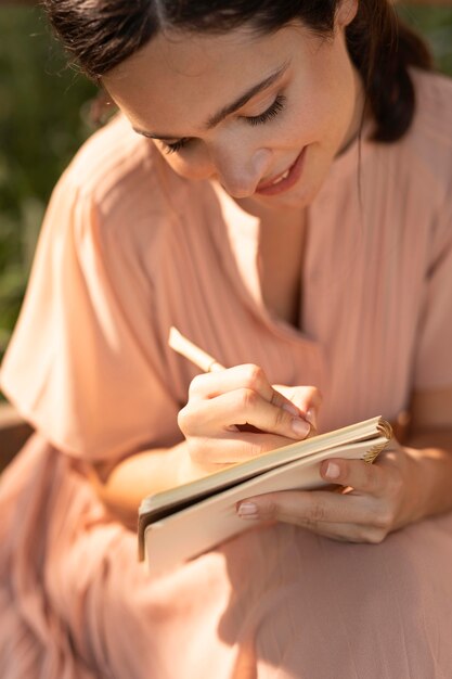 Free Photo close up  smiley woman writing