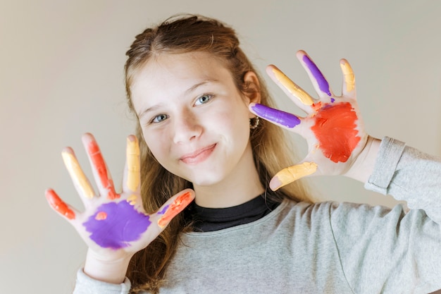 Free Photo close-up of a smiling girl with painted hands