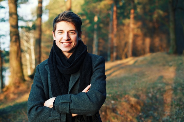 Free photo close-up of smiling man with folded arms in the field