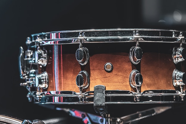 Free photo close-up of a snare drum, percussion instrument on a dark background.