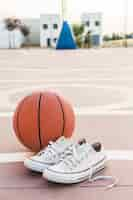 Free photo close-up of sneakers and basketball in court