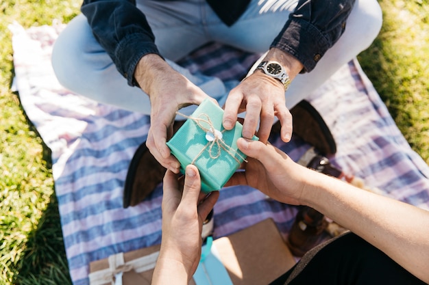 Free Photo close up of son giving present to father