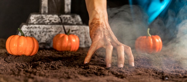 Free photo close-up spooky hand touching the ground