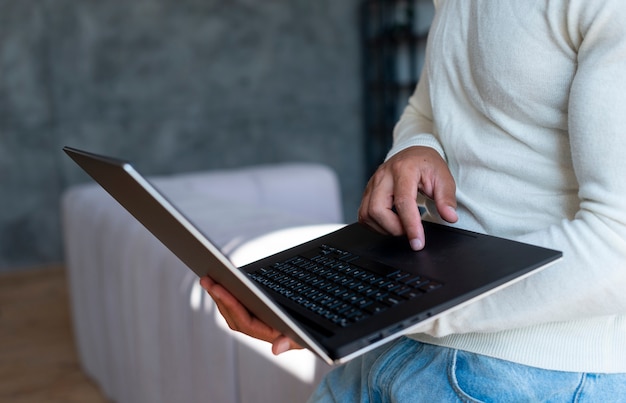 Free photo close-up of standing man using laptop