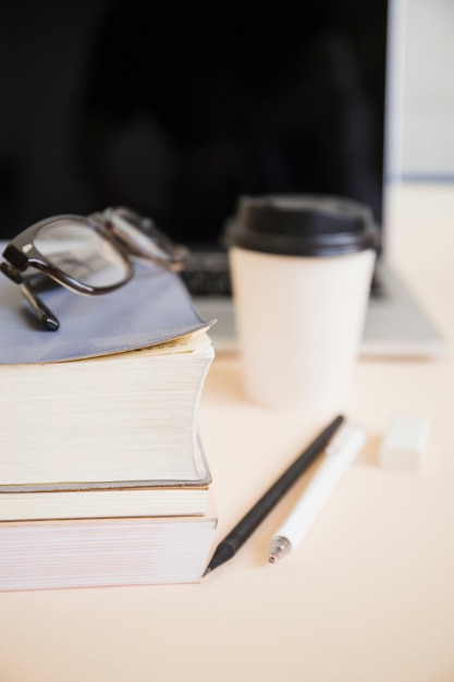 Close-up of stationeries on wooden desk