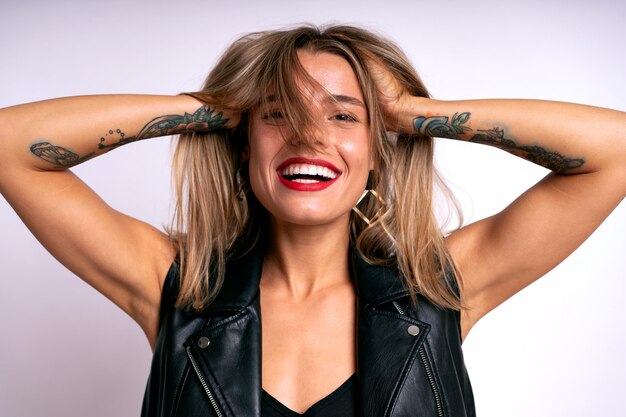 Close up studio positive portrait of pretty woman playing with her hairs happy mood stylish outfit