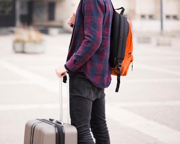 Close-up stylish tourist with luggage