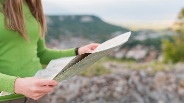 Free Photo close-up stylish woman checking map