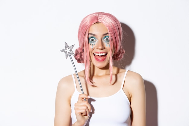 Close-up of surprised happy girl in halloween costume of fairy