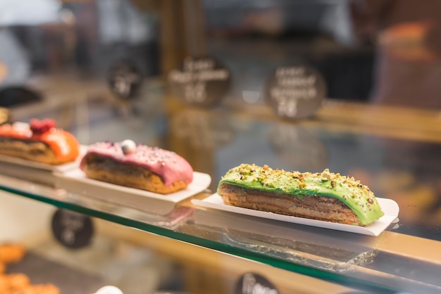 Close-up of sweet slice cake in a glass cabinet