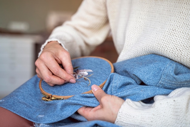 Close-up tailor hands working with needles