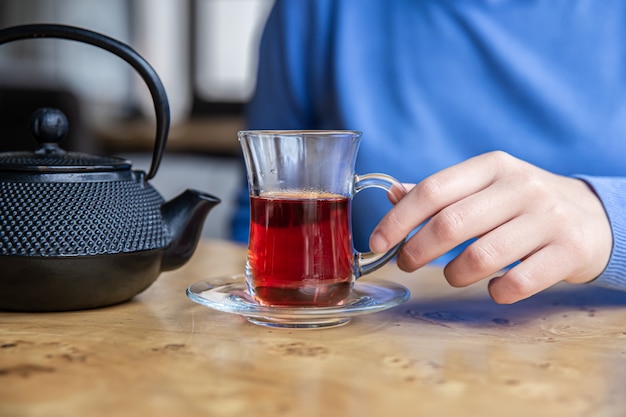 Close up of tea and black textured cast iron teapot