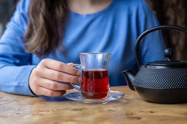 Close up of tea and black textured cast iron teapot