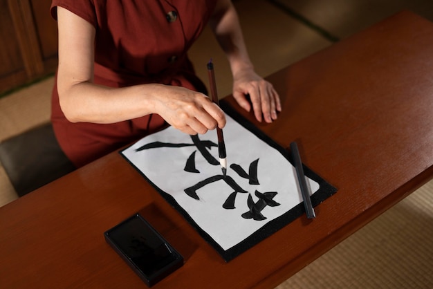 Free photo close up on teacher doing japanese calligraphy, called shodo