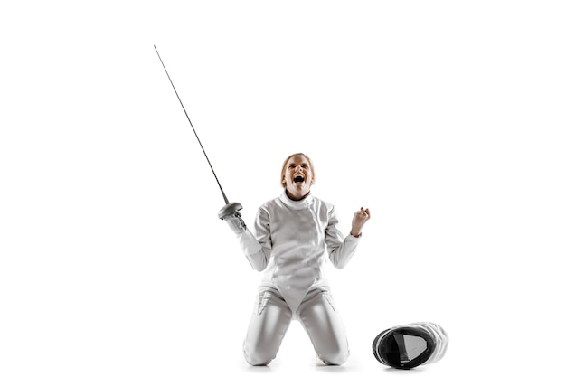 Free photo close up of teen girl in fencing costume with sword in hand isolated on white studio background.