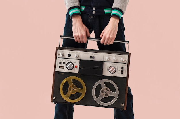 Close-up teenage boy holding cassette