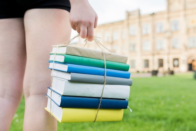 Close up of teenage girl holding books 