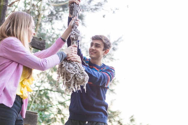 Free Photo close-up of teenagers holding a rope