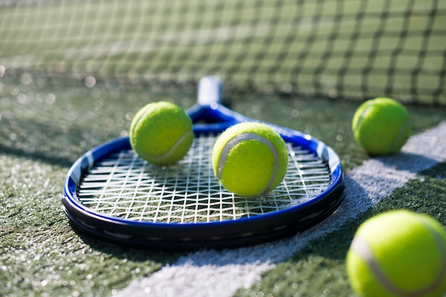 Close-up tennis racket and balls