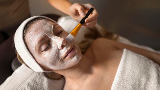 Close-up therapist applying face treatment