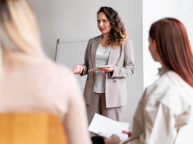 Close up therapist discussing with people