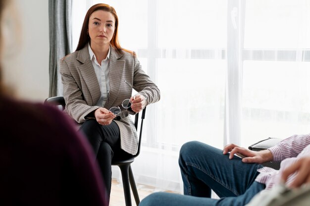 Close up therapist discussing with people