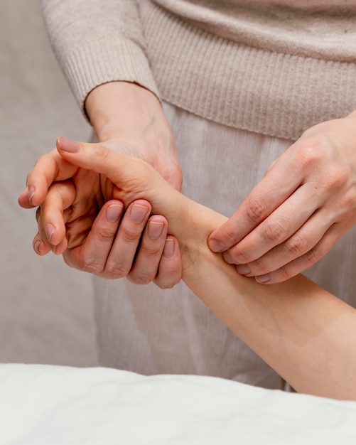 Free photo close up therapist massaging arm