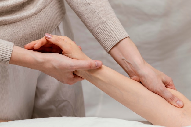 Free photo close up therapist massaging patient's arm