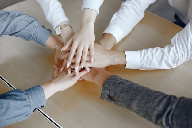 Free photo close up top view of young business people. team putting their hands together. stack of hands. unity and teamwork concept.