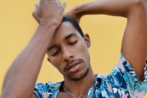 Close up transgender posing with yellow background