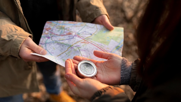 Close up travelers with map and compass