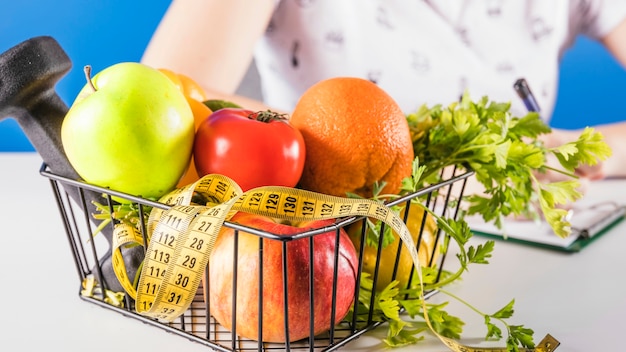 Close-up of a tray with diet food and measuring tape