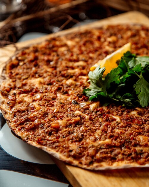 Close up of turkish pizza lahmajun with lemon and parsley