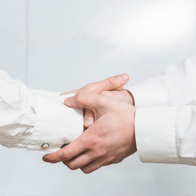 Close-up of two business partners shaking hands