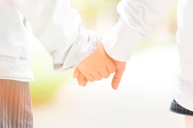 Free photo close-up of two children holding hands