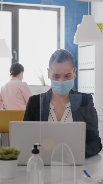 Free photo close up of two coworkers talking about marketing project wearing protective medical face mask sitti...