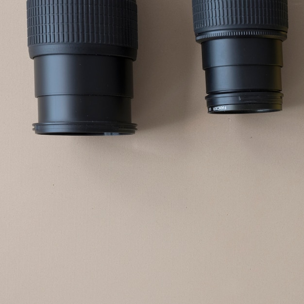 Free Photo close-up of two different professional camera on brown background