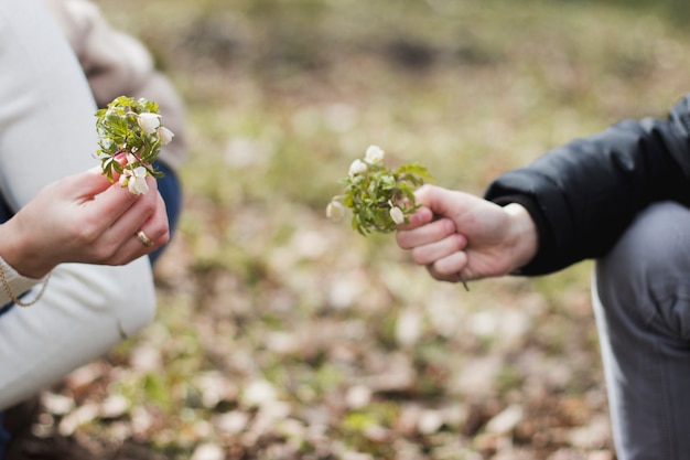 Free photo close-up of two hands with flowers