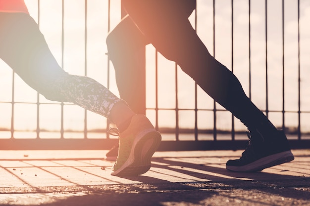 Free photo close-up of two people stretching outdoors