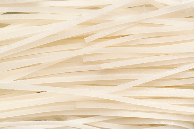 Close-up uncooked white noodles