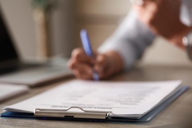 Free photo close up of unrecognizable business person signing documents in the office