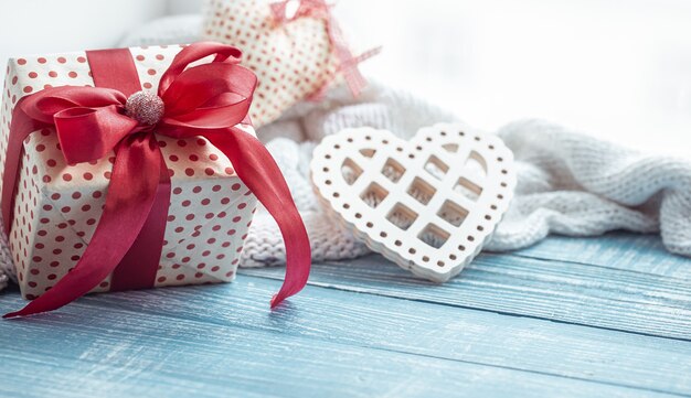 Close up of valentine's day gift and decorative heart on a wooden surface. The concept of the holiday of all lovers.