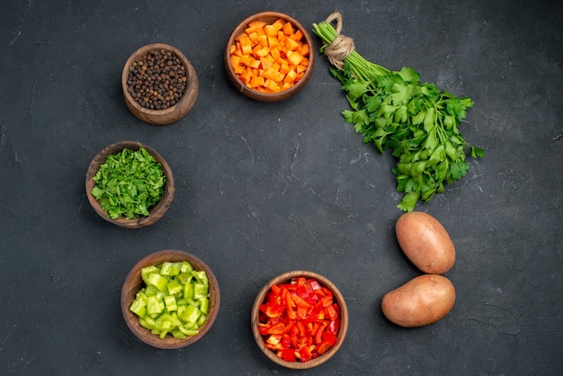 Close up on various chopped vegetables in bowls