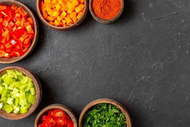 Close up on various chopped vegetables in bowls